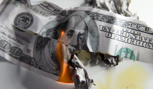 Examining financial risks and strategies to manage debt exposure, illustrated by a burning $100 bill symbolizing financial loss and risk